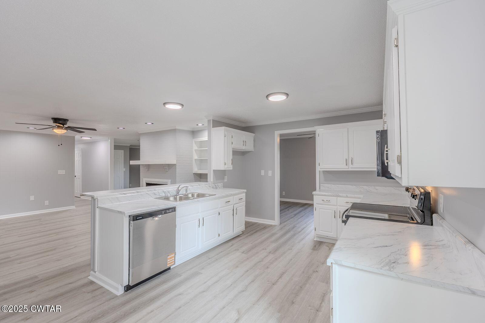 77 Upper Zion Road Brownsville, TN 38012 - Photo 7 of 27 a kitchen with a sink stove and cabinets