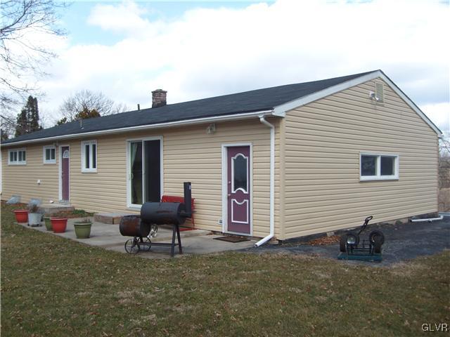 2276 Jordan Road Orefield, PA 18069 - Photo 16 of 17 a backyard of a house with wooden fence table and chairs