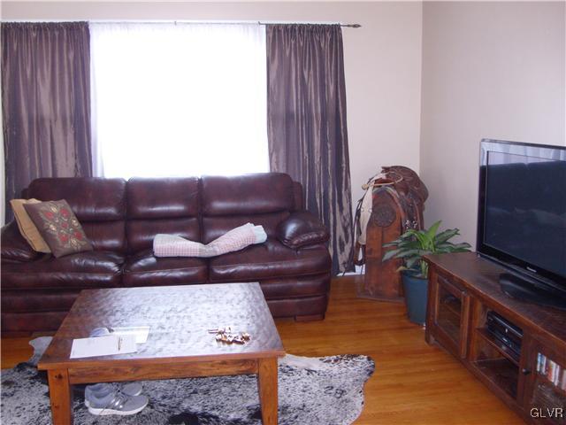 2276 Jordan Road Orefield, PA 18069 - Photo 4 of 17 a living room with furniture and a flat screen tv