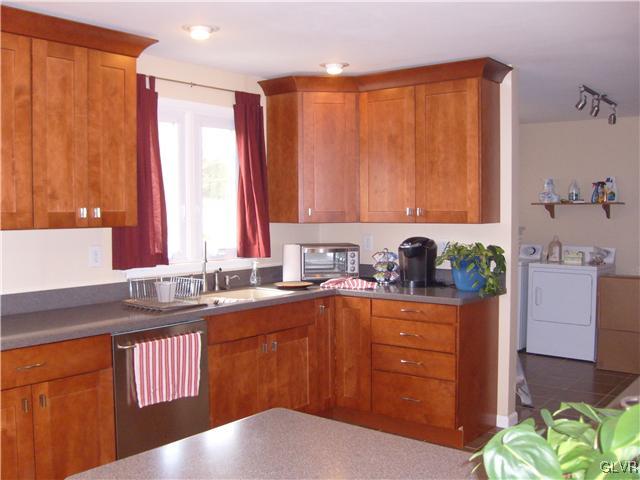 2276 Jordan Road Orefield, PA 18069 - Photo 6 of 17 a kitchen with a sink stove and cabinets