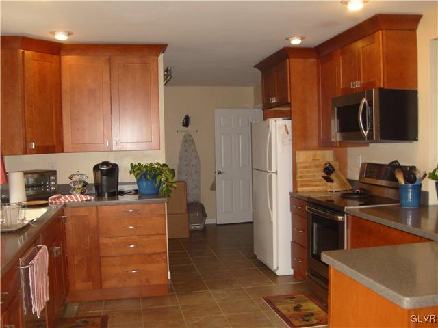 2276 Jordan Road Orefield, PA 18069 - Photo 7 of 17 a kitchen with stainless steel appliances granite countertop a refrigerator stove and sink