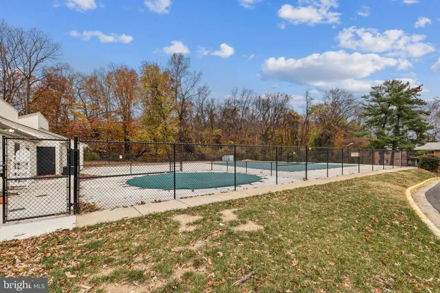 a view of a yard with wooden fence