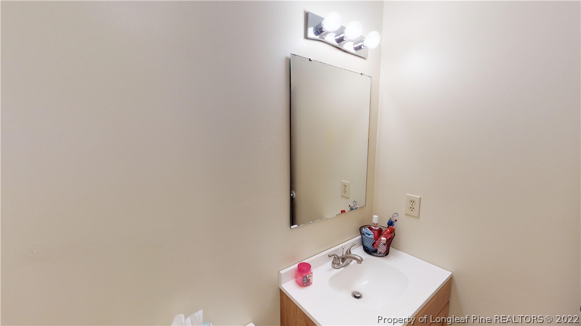 508 Jennings Farm Road Fayetteville, NC 28314 - Photo 14 of 24 a bathroom with a sink and a mirror