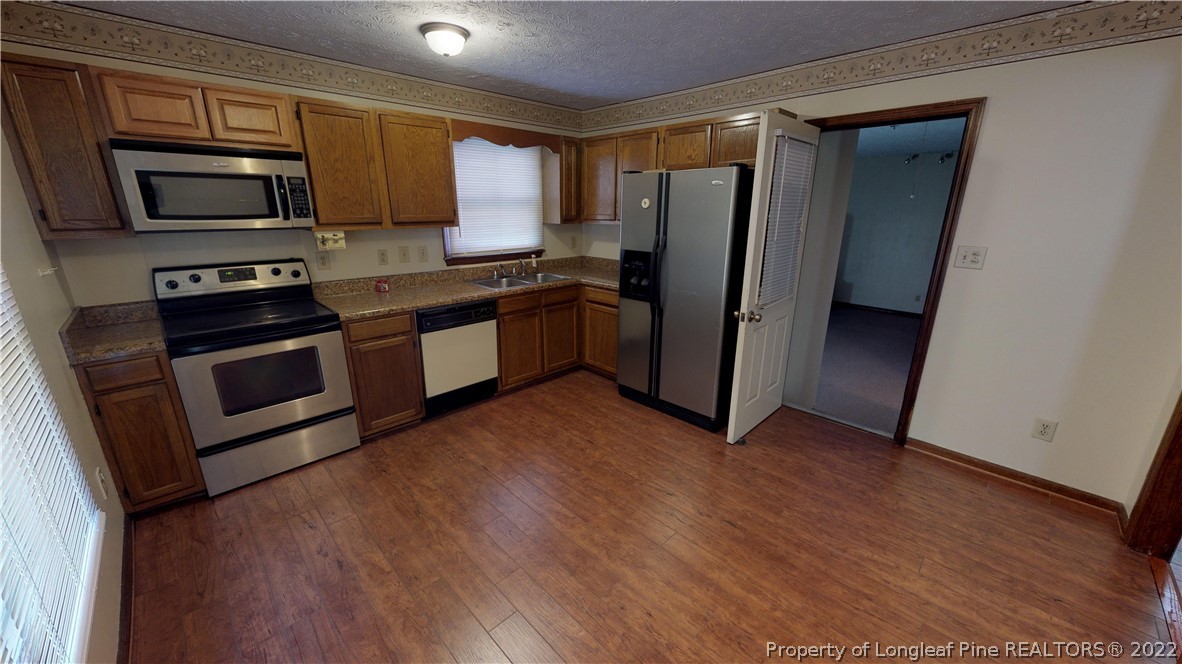 508 Jennings Farm Road Fayetteville, NC 28314 - Photo 5 of 24 a kitchen with stainless steel appliances a refrigerator stove and microwave