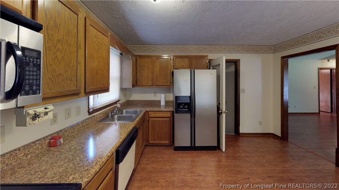 508 Jennings Farm Road Fayetteville, NC 28314 - Photo 6 of 24 a kitchen with stainless steel appliances granite countertop a refrigerator and a sink