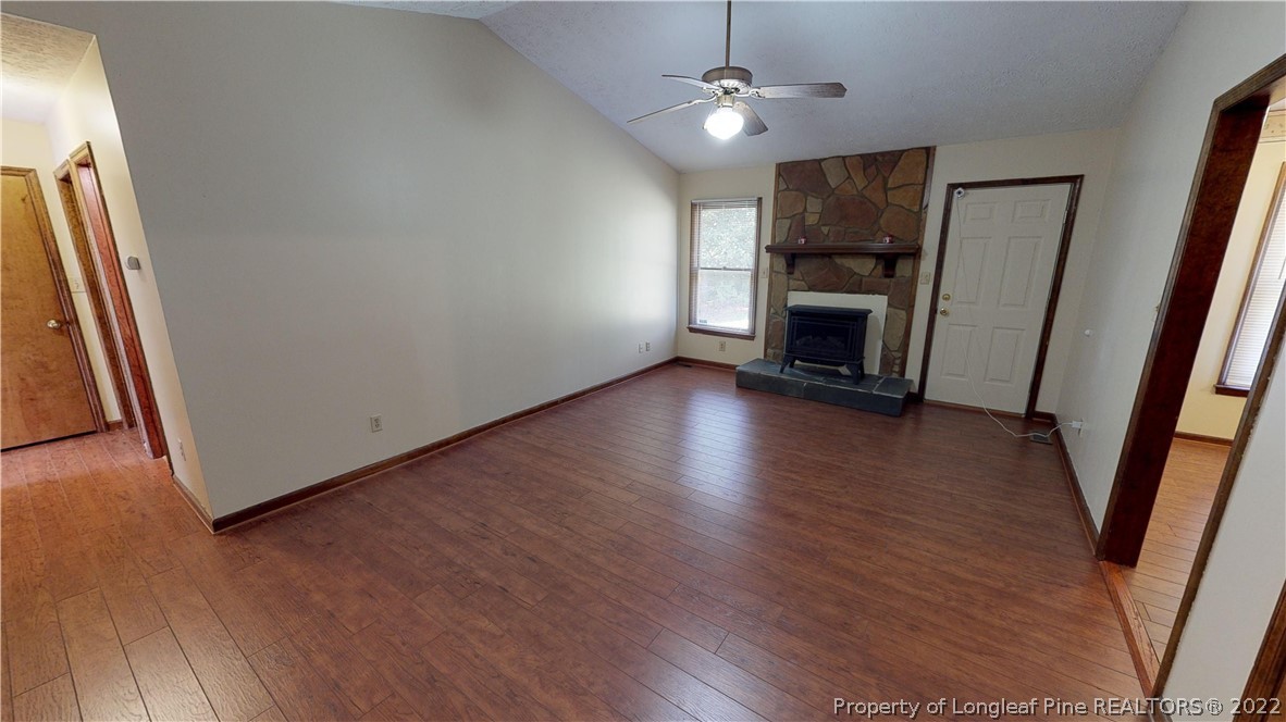 508 Jennings Farm Road Fayetteville, NC 28314 - Photo 8 of 24 an empty room with wooden floor and a ceiling fan