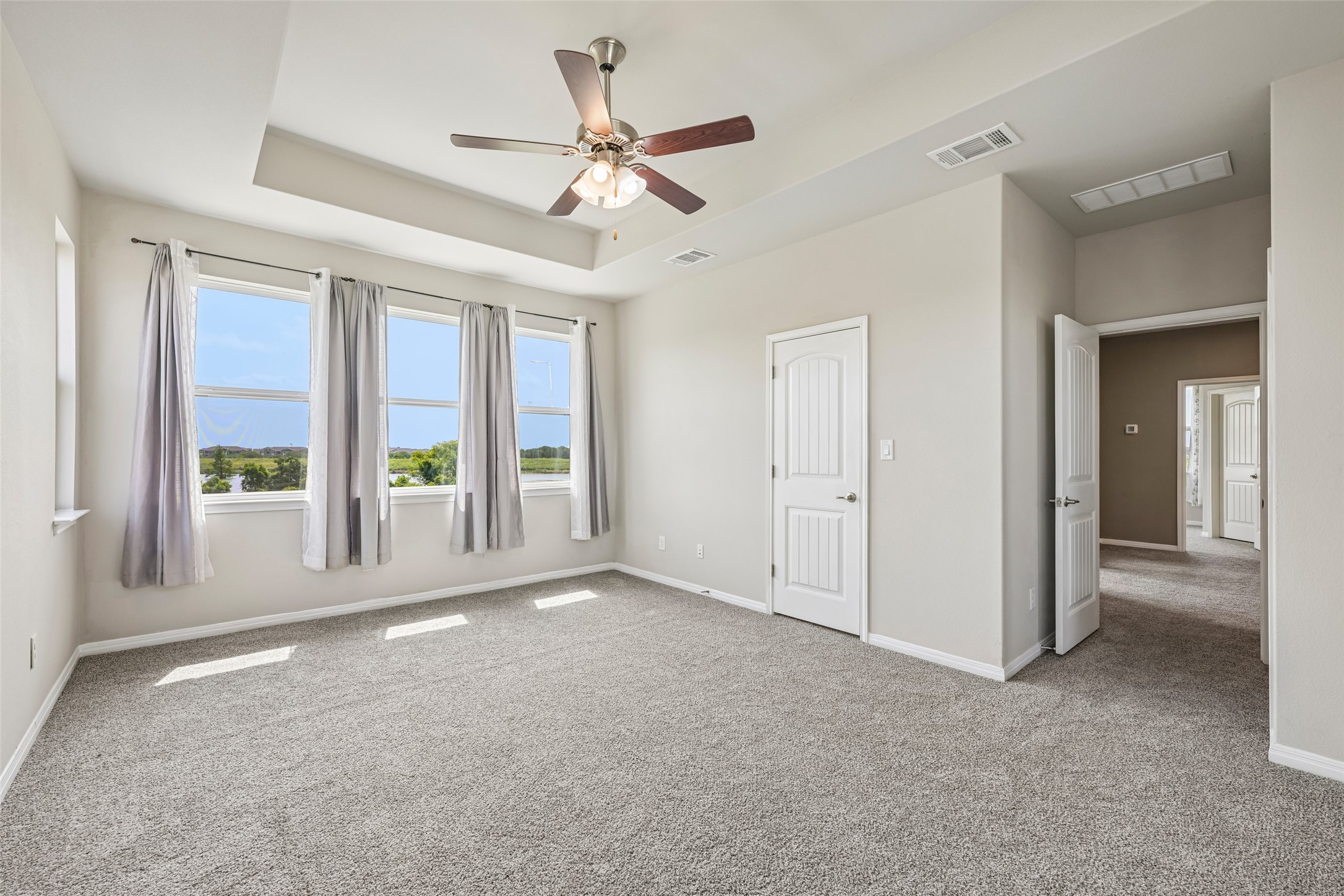 1297 Harwell Loop Kyle, TX 78640 - Photo 20 of 39 A spacious chamber with a vaulted ceiling and panoramic views, ready for personalization.