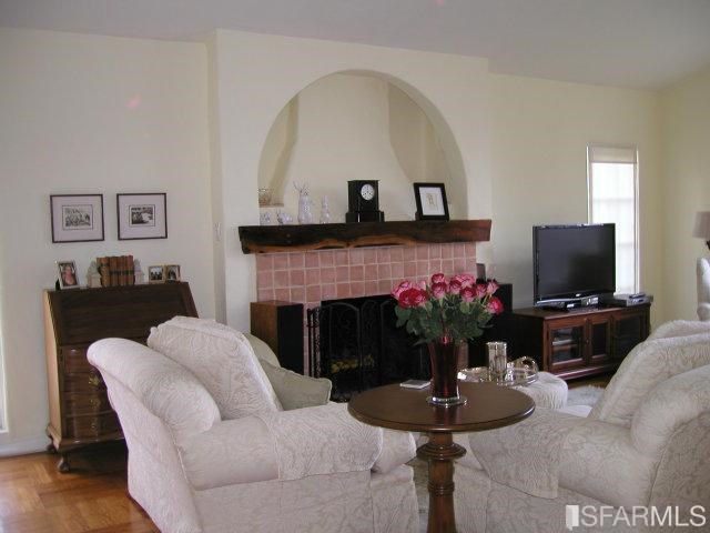 149 Warren Road San Mateo, CA 94401 - Photo 4 of 10 a living room with furniture a fireplace and a flat screen tv
