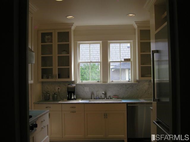 149 Warren Road San Mateo, CA 94401 - Photo 6 of 10 a kitchen with a sink window and cabinets