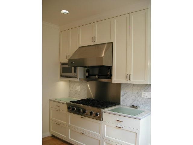 149 Warren Road San Mateo, CA 94401 - Photo 8 of 10 a kitchen with granite countertop a stove and a microwave