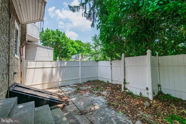 a backyard of a house with a table and chairs