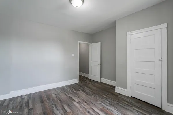 a view of an empty room and wooden floor