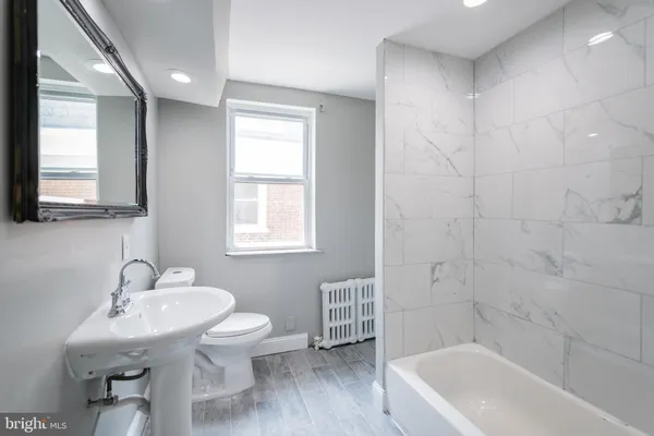 a bathroom with a sink toilet a tub and shower