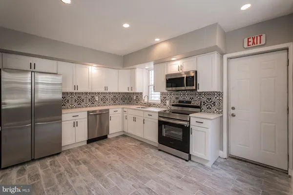 a kitchen with a refrigerator stove and microwave