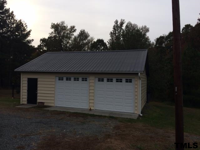 1655 Gate 2 Road Creedmoor, NC 27522 - Photo 2 of 3 a black and white building with trees in the background