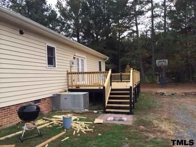 1655 Gate 2 Road Creedmoor, NC 27522 - Photo 3 of 3 a front view of a house with a garden