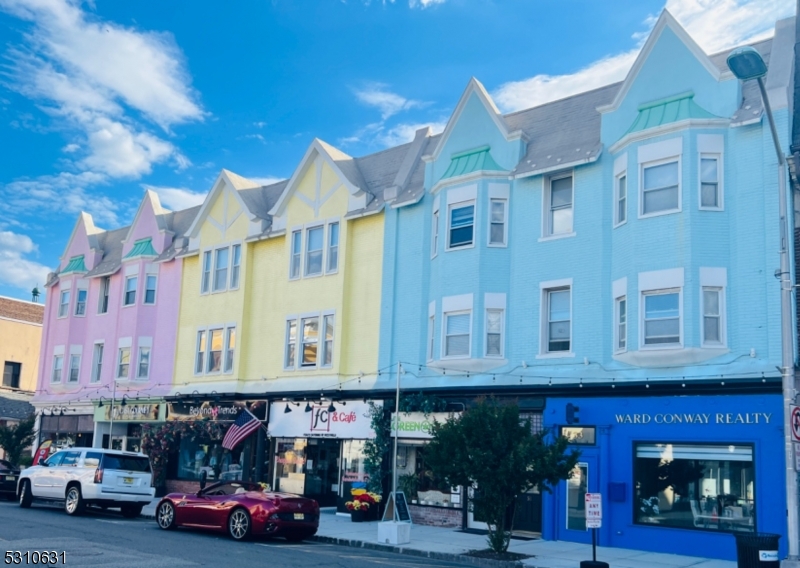 a front view of building with cars parked