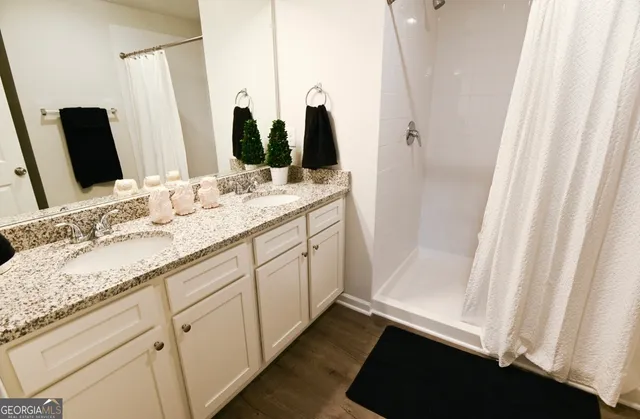 a bathroom with a double vanity sink and a mirror