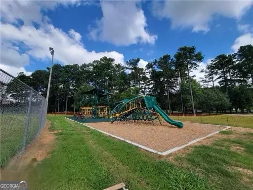 a view of a park with swings and slides