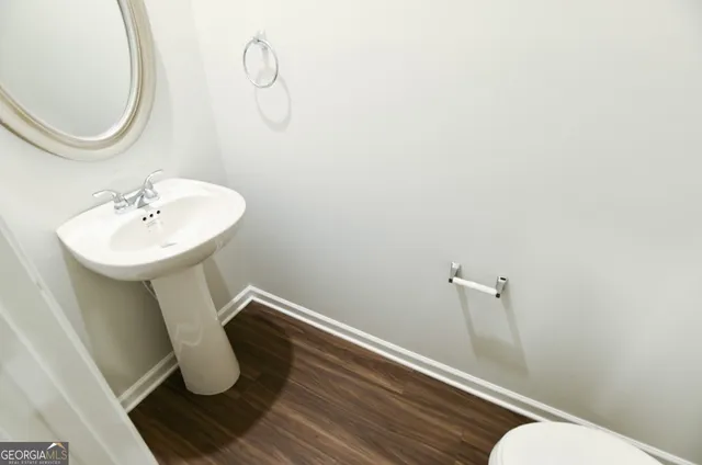 a bathroom with a sink mirror and toilet