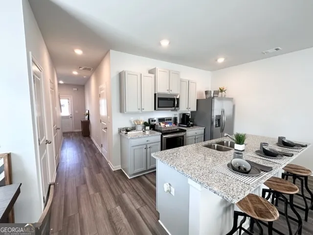a kitchen with white cabinets and stainless steel appliances