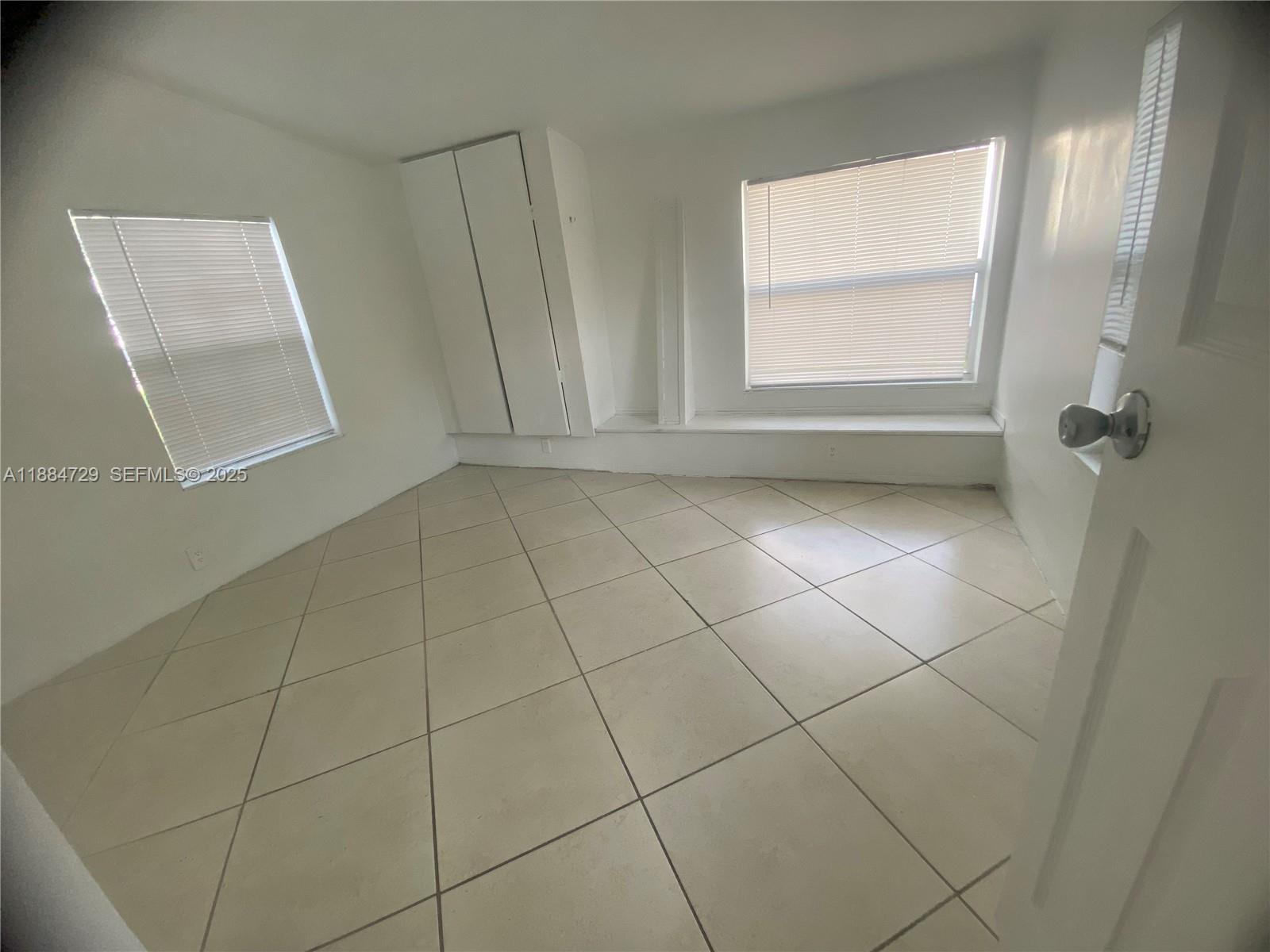 4557 Northwest 3rd Street Plantation, FL 33317 - Photo 2 of 11 a bathroom with a window and a shower