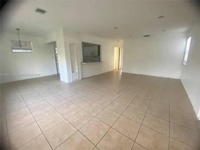 an empty room with a empty space and windows