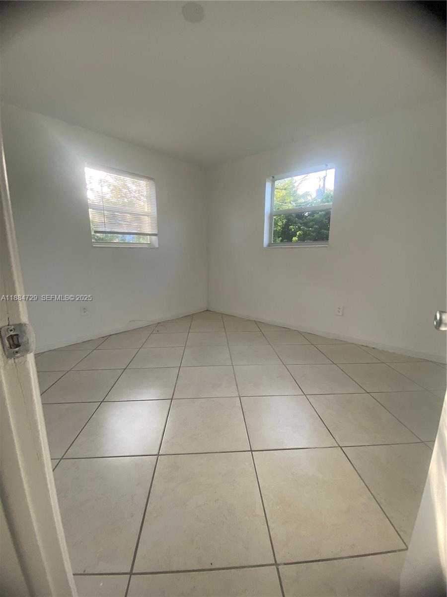 4557 Northwest 3rd Street Plantation, FL 33317 - Photo 6 of 11 a view of an empty room and a window