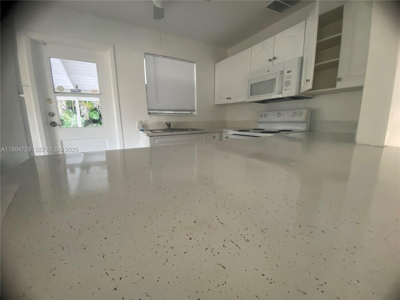 4557 Northwest 3rd Street Plantation, FL 33317 - Photo 9 of 11 a view of kitchen with stove top oven