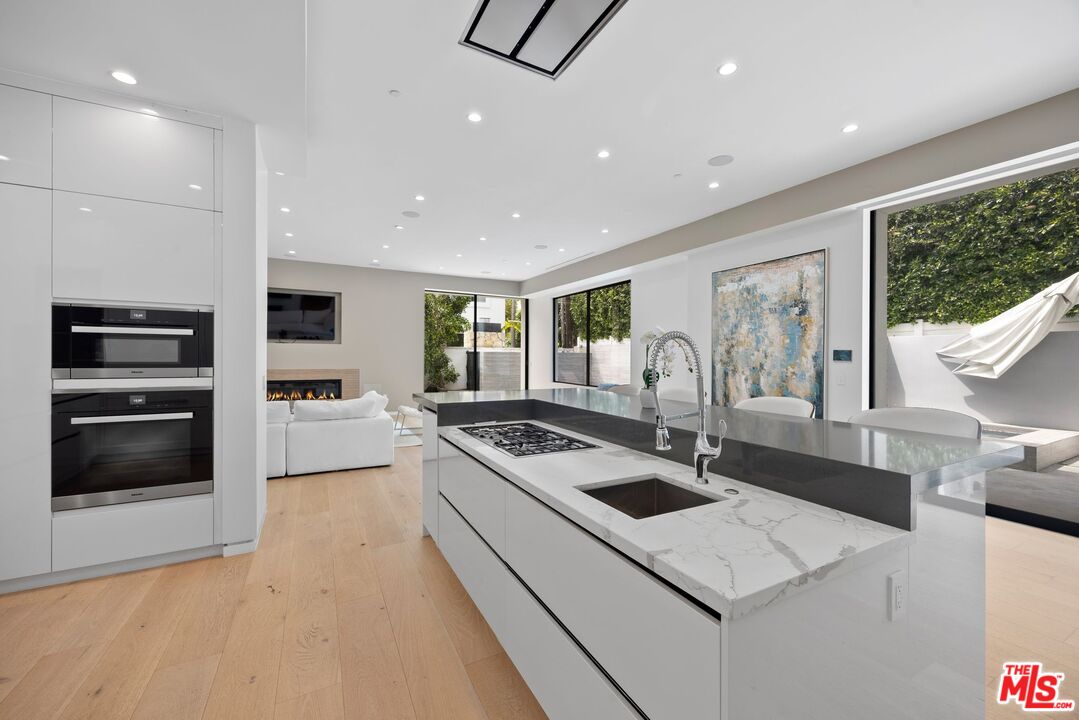 839 North Spaulding Avenue Los Angeles, CA 90046 - Photo 11 of 46 a kitchen with granite countertop a sink and a stove top oven