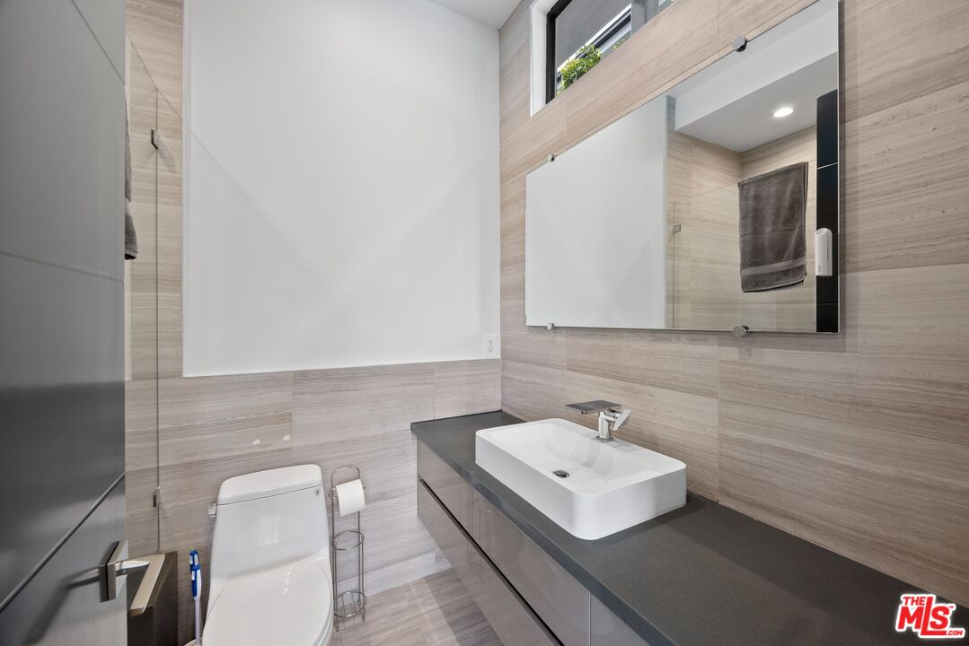 839 North Spaulding Avenue Los Angeles, CA 90046 - Photo 22 of 46 a bathroom with a sink a toilet and mirror