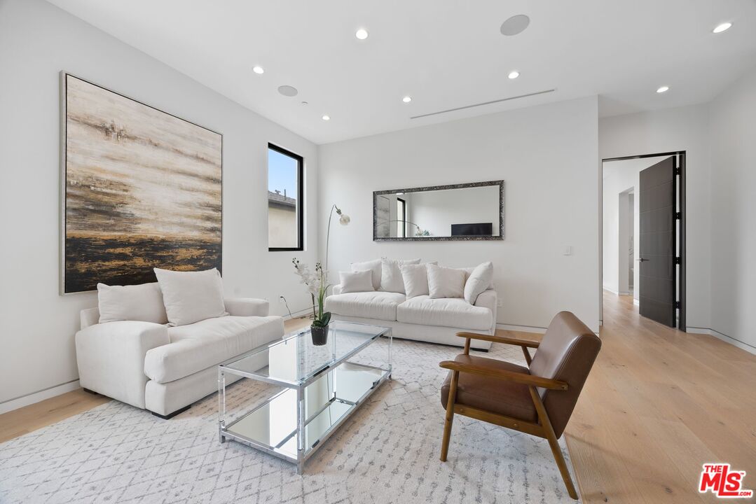 839 North Spaulding Avenue Los Angeles, CA 90046 - Photo 25 of 46 a living room with furniture and a large window