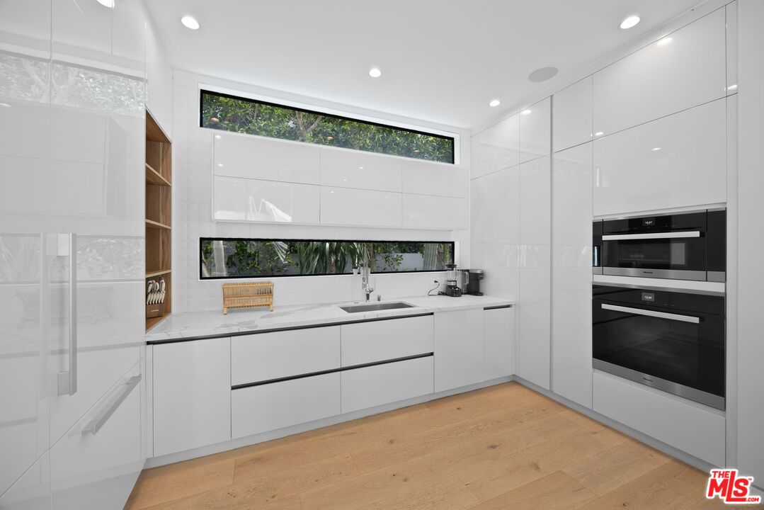 839 North Spaulding Avenue Los Angeles, CA 90046 - Photo 10 of 46 a kitchen with a sink and stainless steel appliances