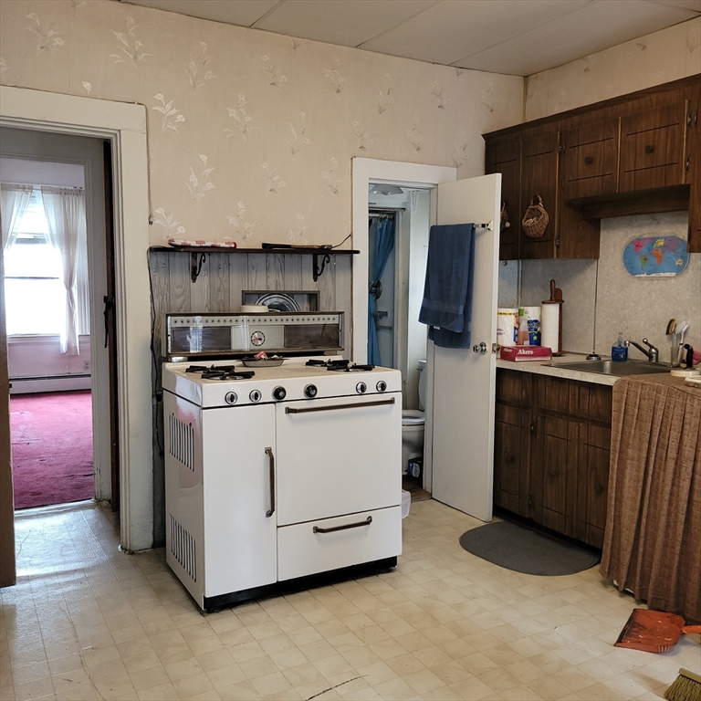 467 East 3rd Street Boston, MA 02127 - Photo 7 of 18 a kitchen with stainless steel appliances kitchen island a sink stove and refrigerator