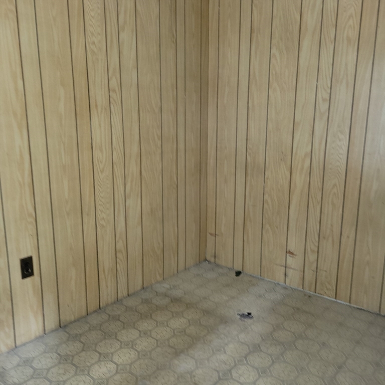 467 East 3rd Street Boston, MA 02127 - Photo 8 of 18 a view of an empty room with a wooden wall