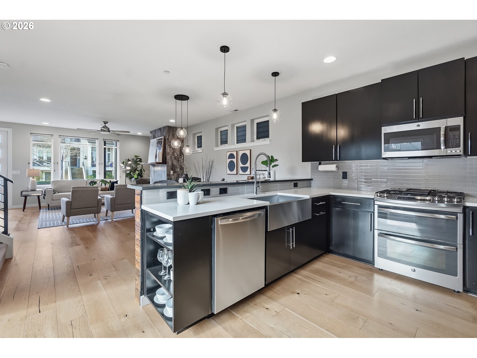 11375 Southwest Barber Street Wilsonville, OR 97070 - Photo 12 of 26 a kitchen with stainless steel appliances kitchen island a sink stove and cabinets