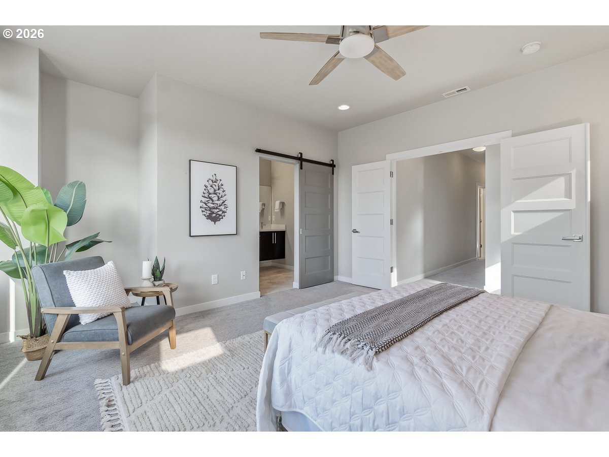 11375 Southwest Barber Street Wilsonville, OR 97070 - Photo 14 of 26 a bedroom with a bed and furniture