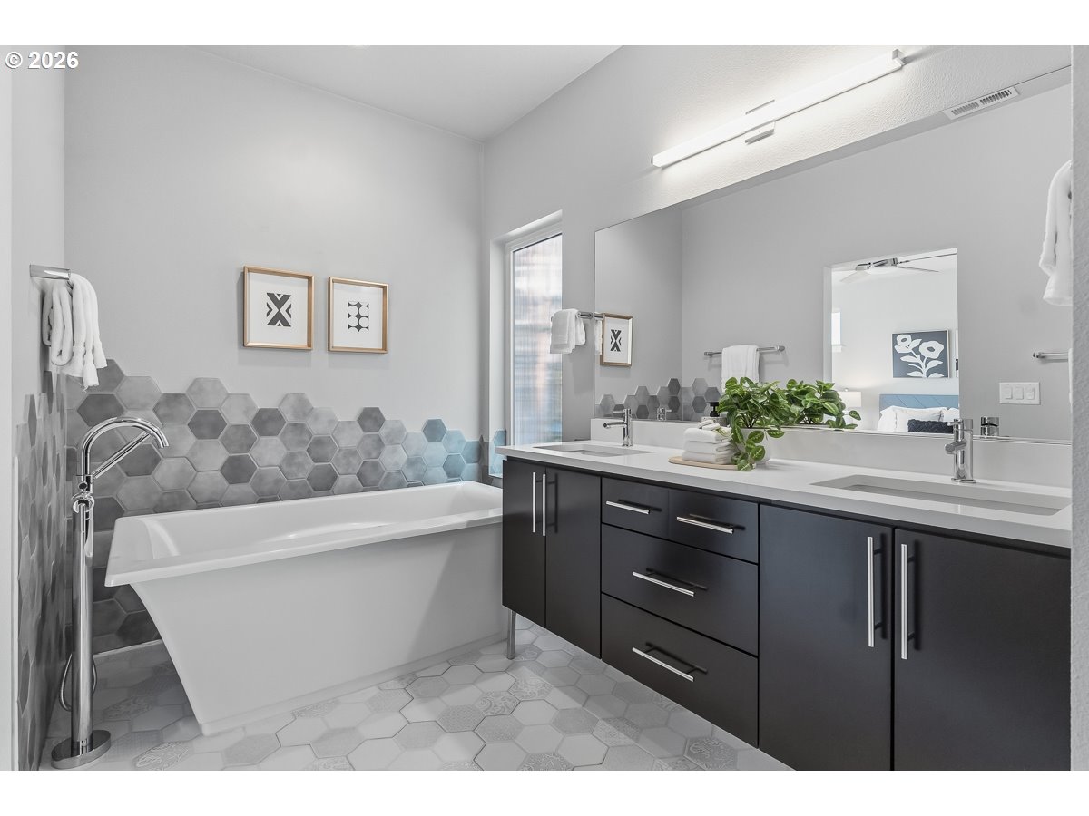 11375 Southwest Barber Street Wilsonville, OR 97070 - Photo 16 of 26 a bathroom with a bathtub sink and mirror