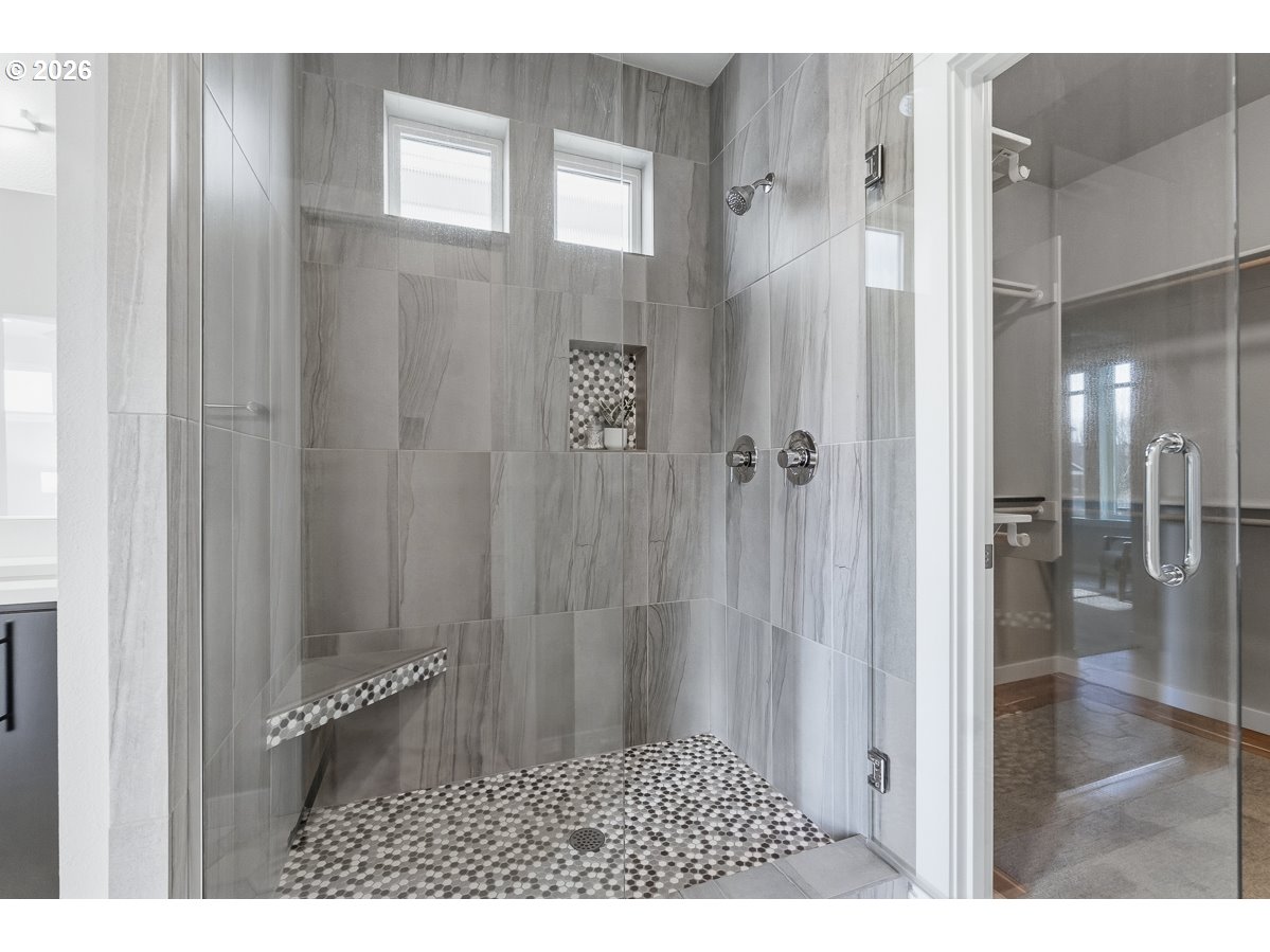 11375 Southwest Barber Street Wilsonville, OR 97070 - Photo 17 of 26 a bathroom with a glass shower door