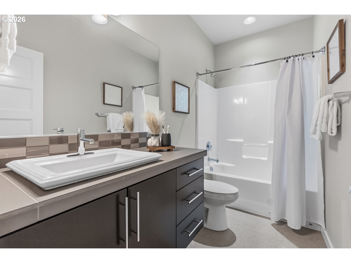 11375 Southwest Barber Street Wilsonville, OR 97070 - Photo 18 of 26 a bathroom with a shower sink vanity mirror and toilet