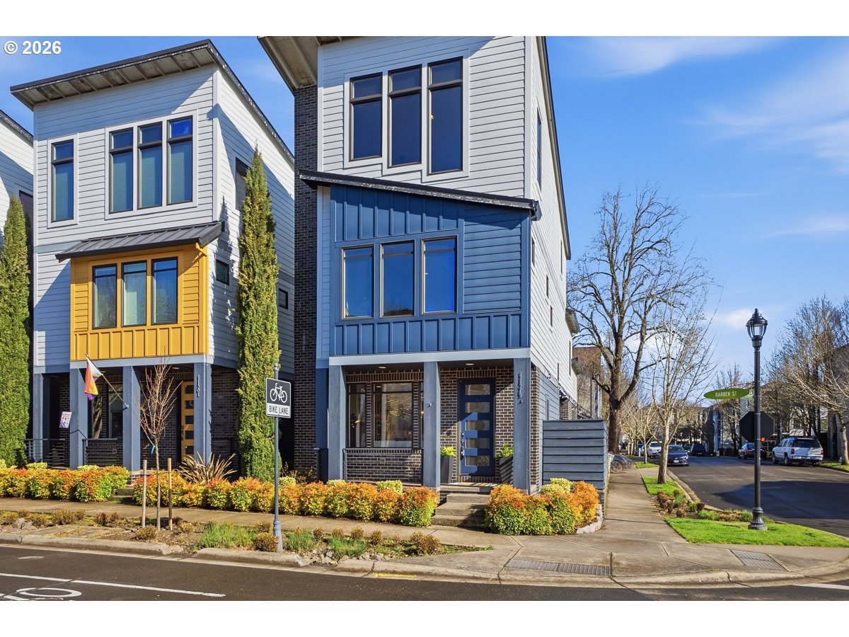 11375 Southwest Barber Street Wilsonville, OR 97070 - Photo 2 of 26 a front view of a house with a yard