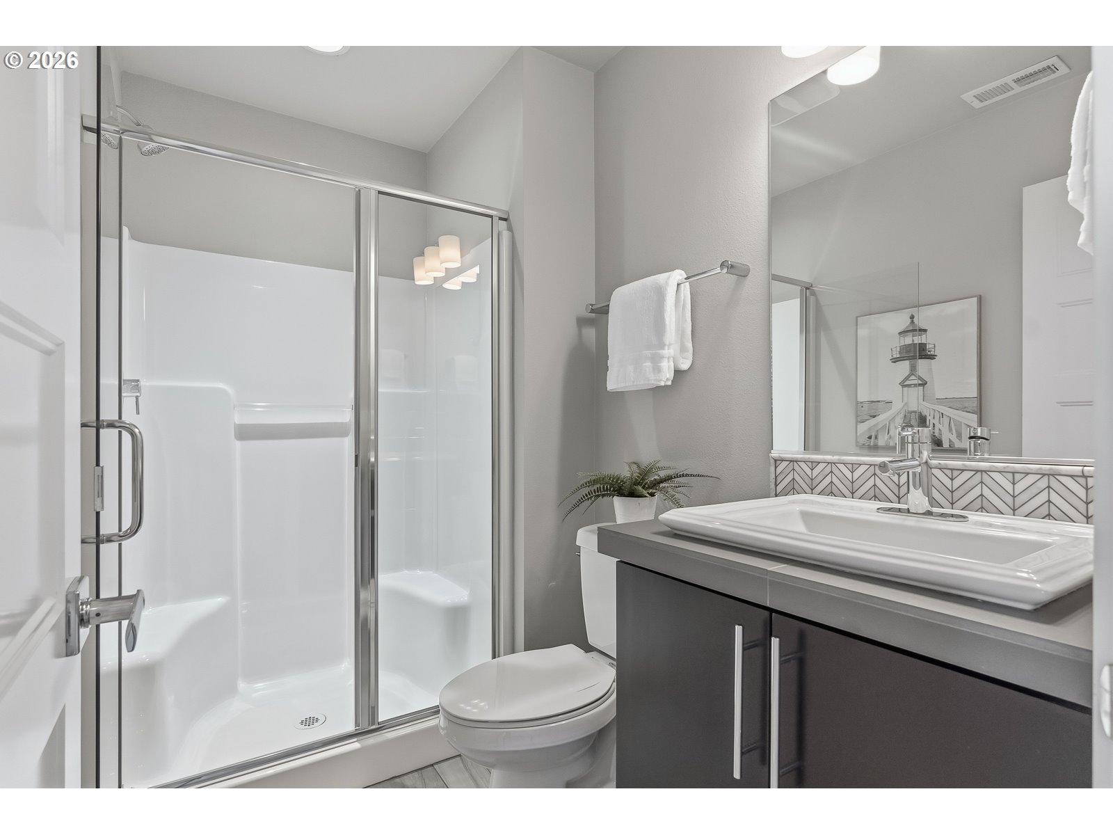 11375 Southwest Barber Street Wilsonville, OR 97070 - Photo 24 of 26 a bathroom with a sink toilet and shower