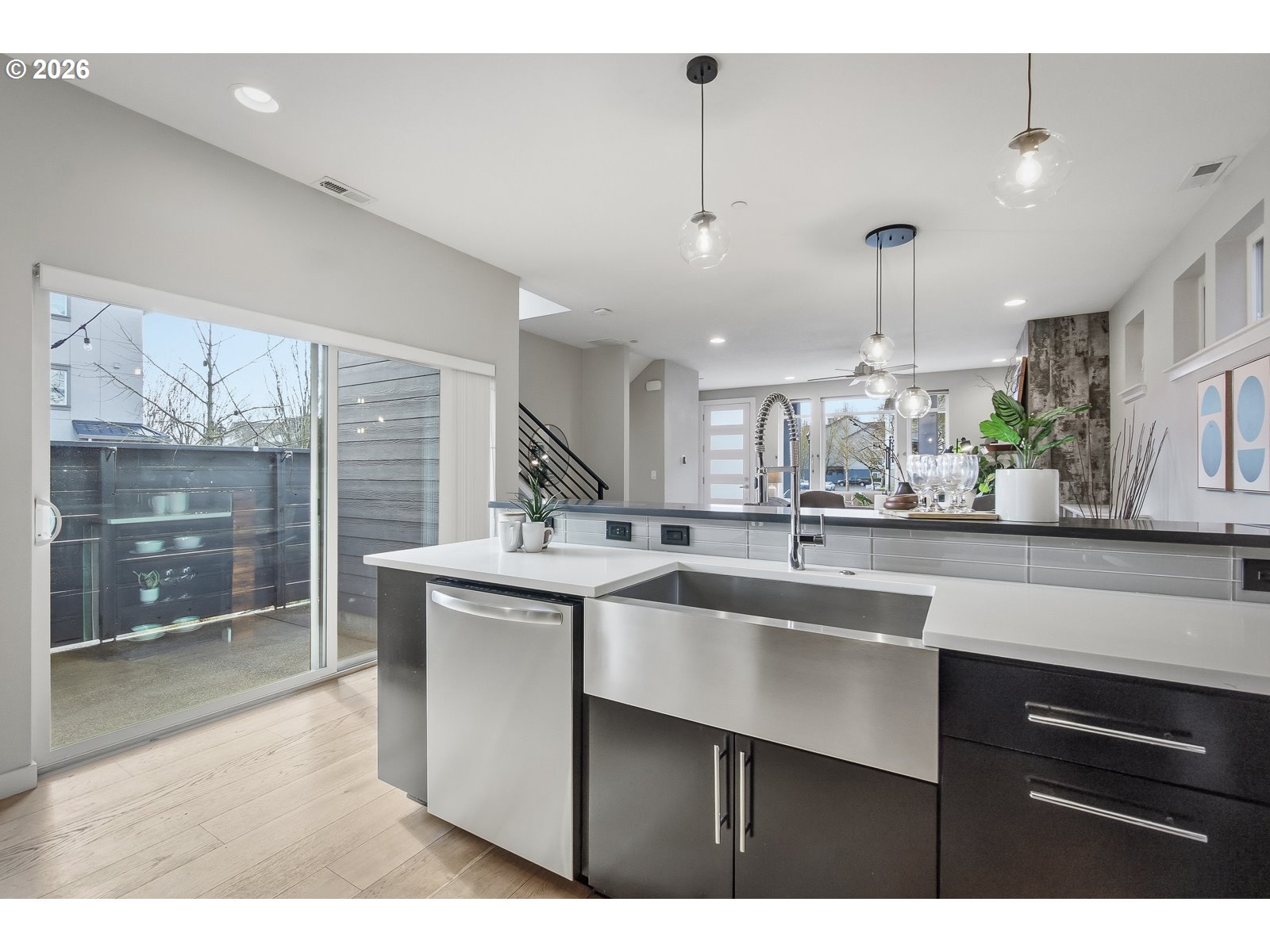 11375 Southwest Barber Street Wilsonville, OR 97070 - Photo 10 of 26 a kitchen with stainless steel appliances kitchen island a sink cabinets and wooden floor