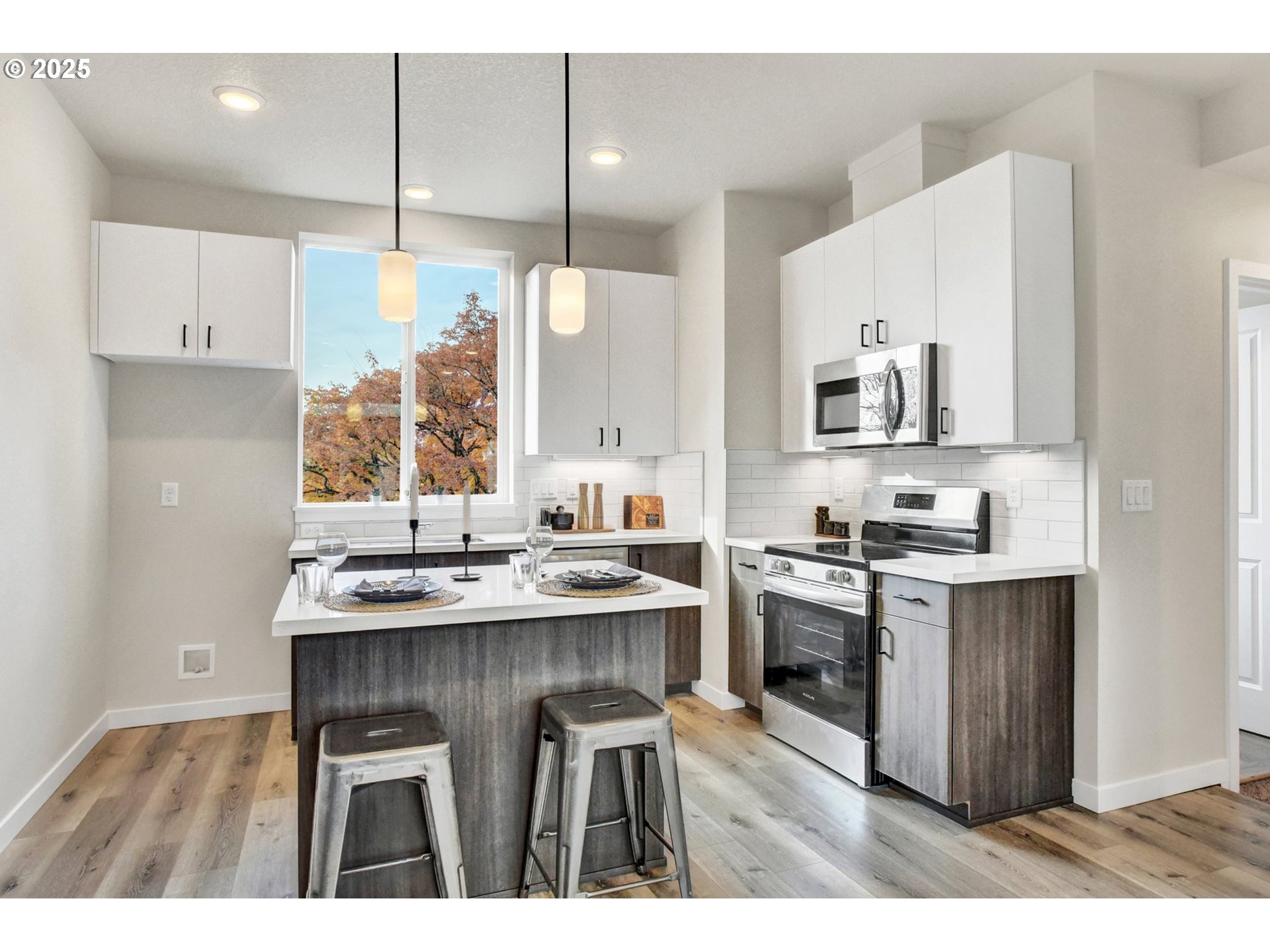 1669 Southeast Sherrett Street Portland, OR 97202 - Photo 6 of 14 a kitchen with kitchen island granite countertop a sink appliances cabinets and a counter top space