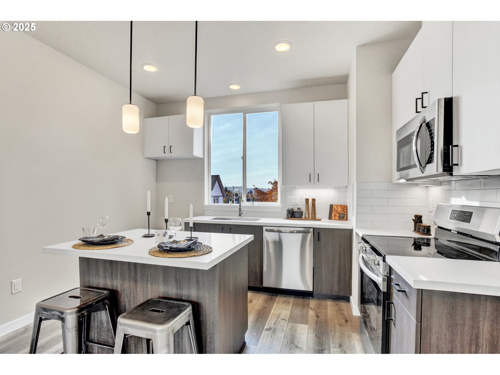 1669 Southeast Sherrett Street Portland, OR 97202 - Photo 7 of 14 a kitchen with stainless steel appliances a sink a stove a refrigerator and cabinets