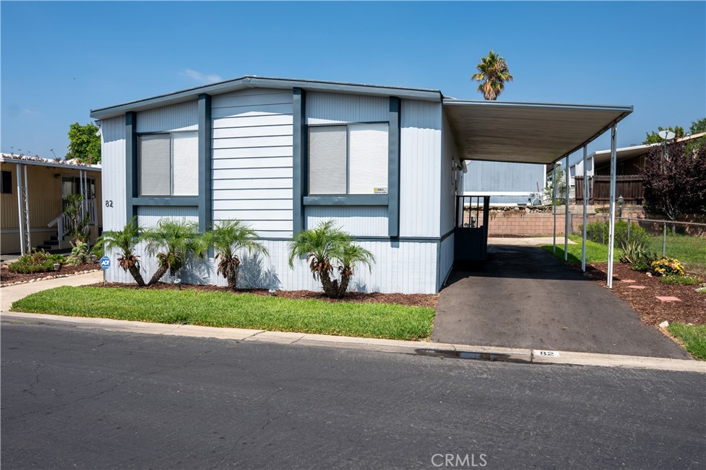 1350 San Bernardino Road, Unit 82 Upland, CA 91786 - Photo 1 of 1 a front view of a house with a yard and potted plants