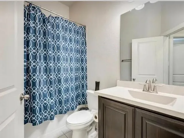 a bathroom with a sink toilet and a mirror