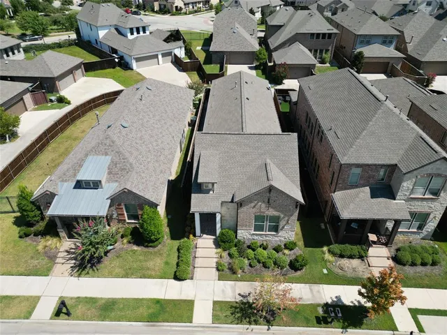 an aerial view of multiple houses with yard