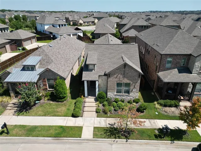 a aerial view of a house with a yard and plants