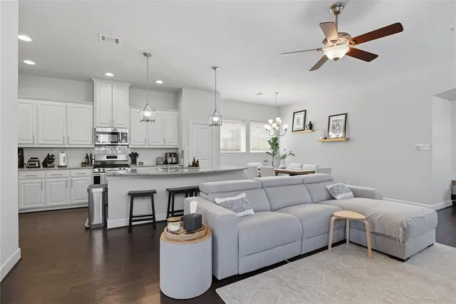a living room with furniture and kitchen view